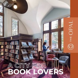 a woman reading a book in a library