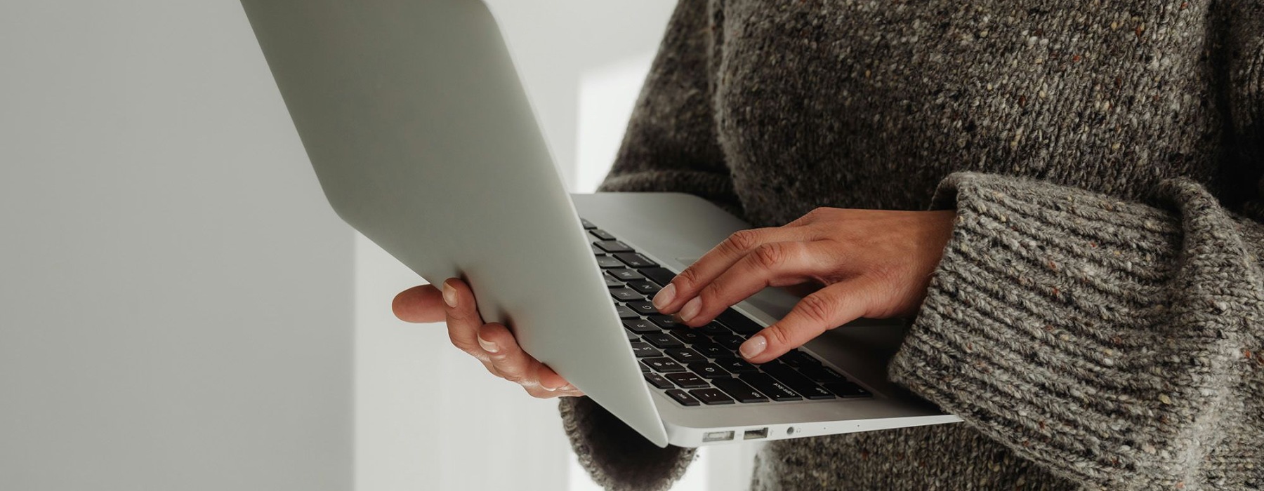 A person holding a laptop.
