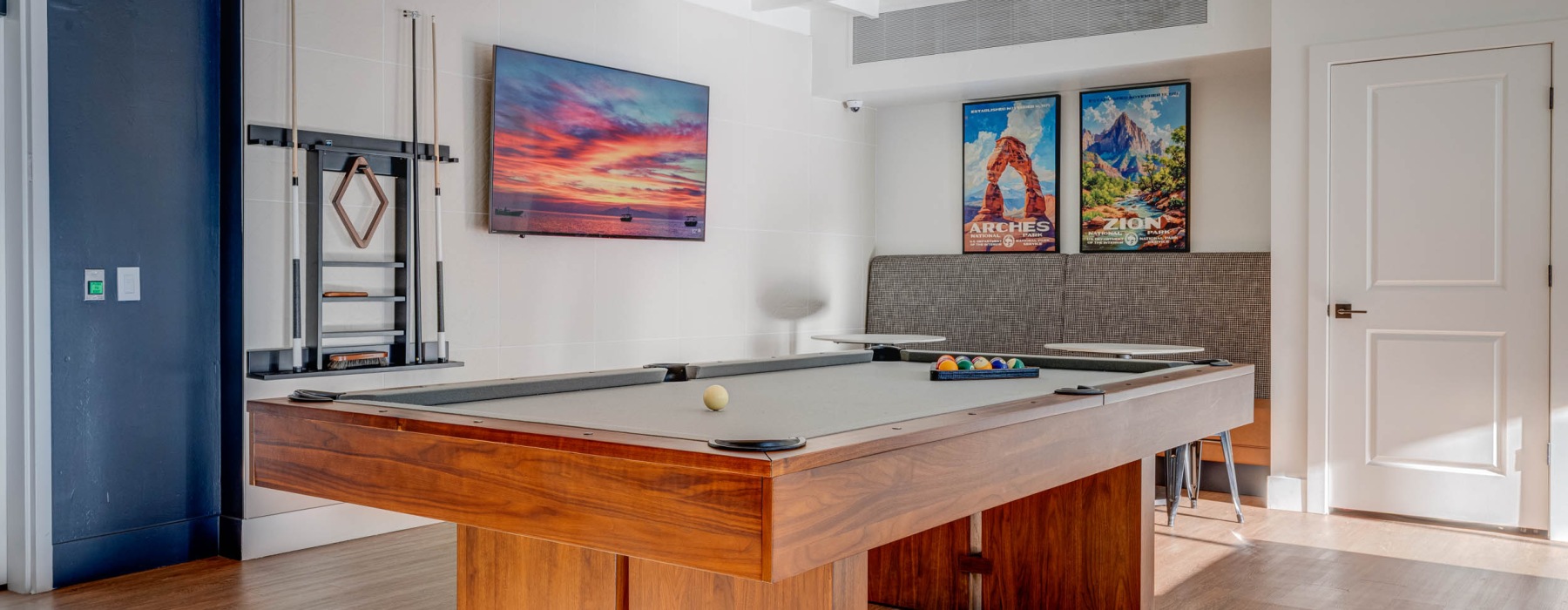 a clubroom with a pool table and wall art