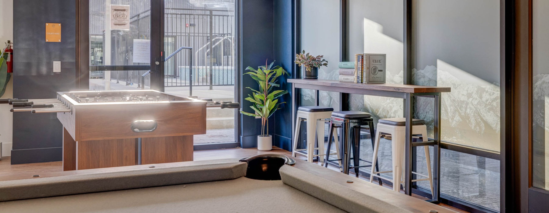a clubroom with pool tables and chairs